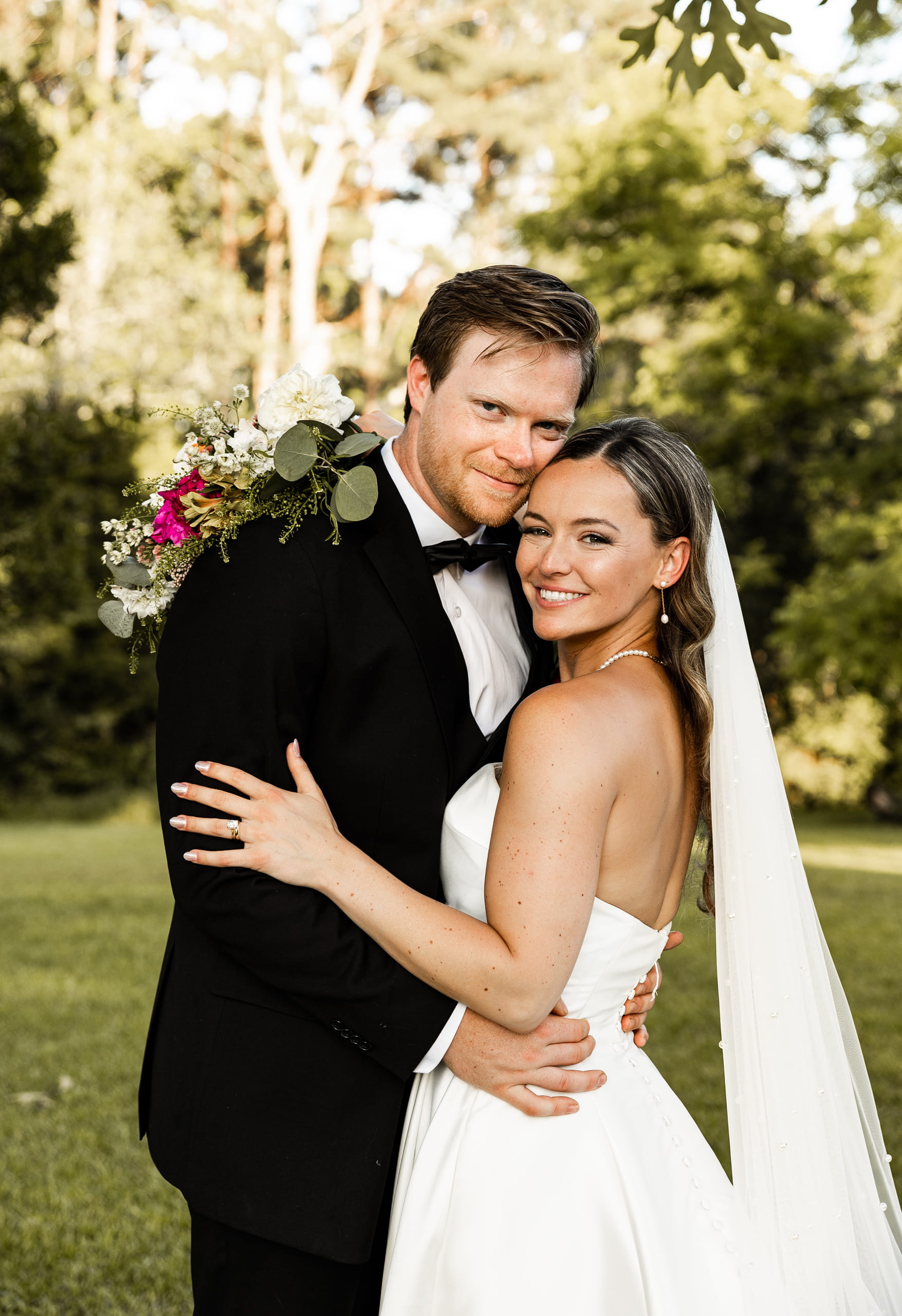 Andrew and Alyssa posing closely like a family, sharing a tender embrace that reflects warmth and connection.
