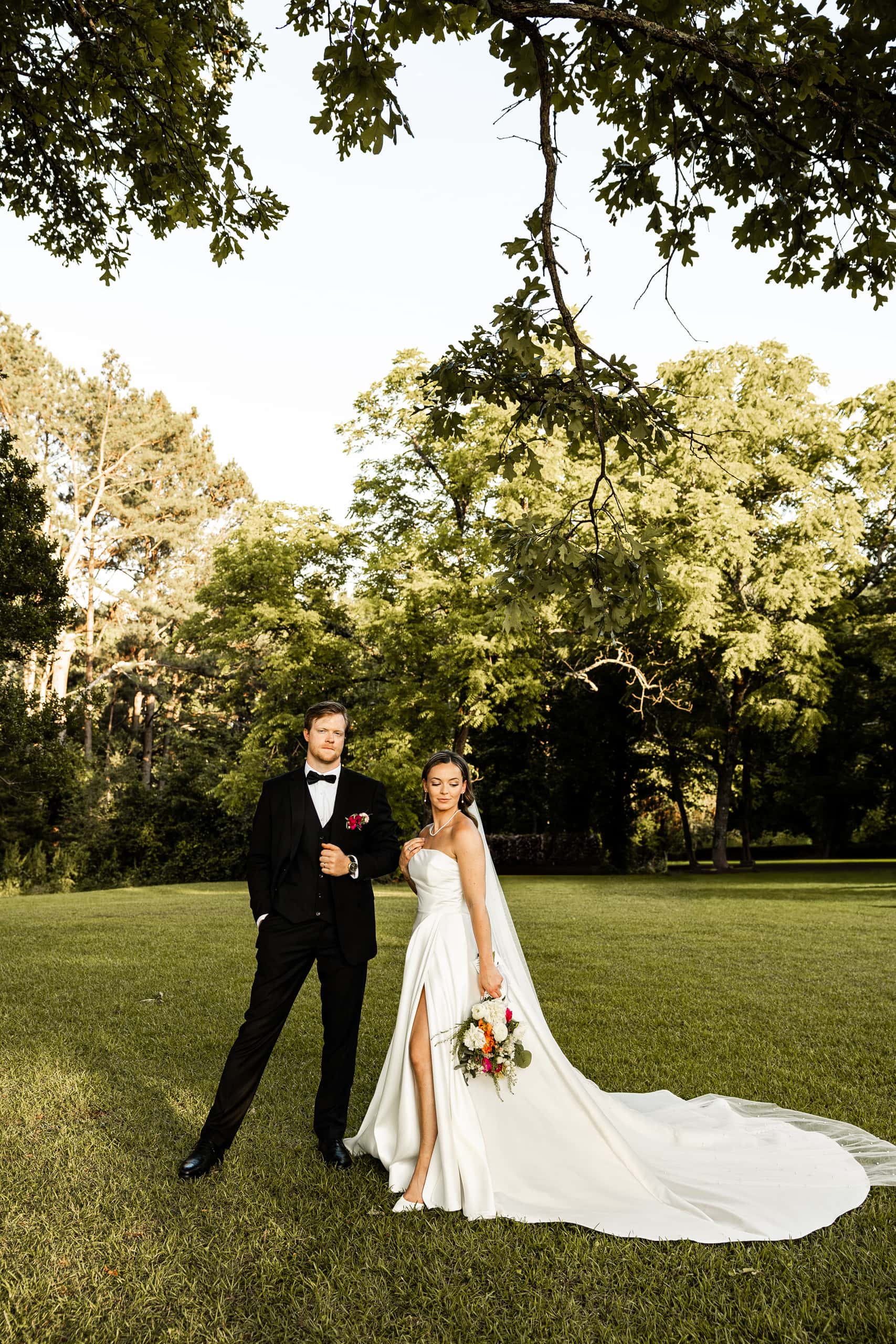 Bride and groom Andrew and Alyssa smiling and laughing together, captured in a candid, family-like moment full of joy and intimacy.