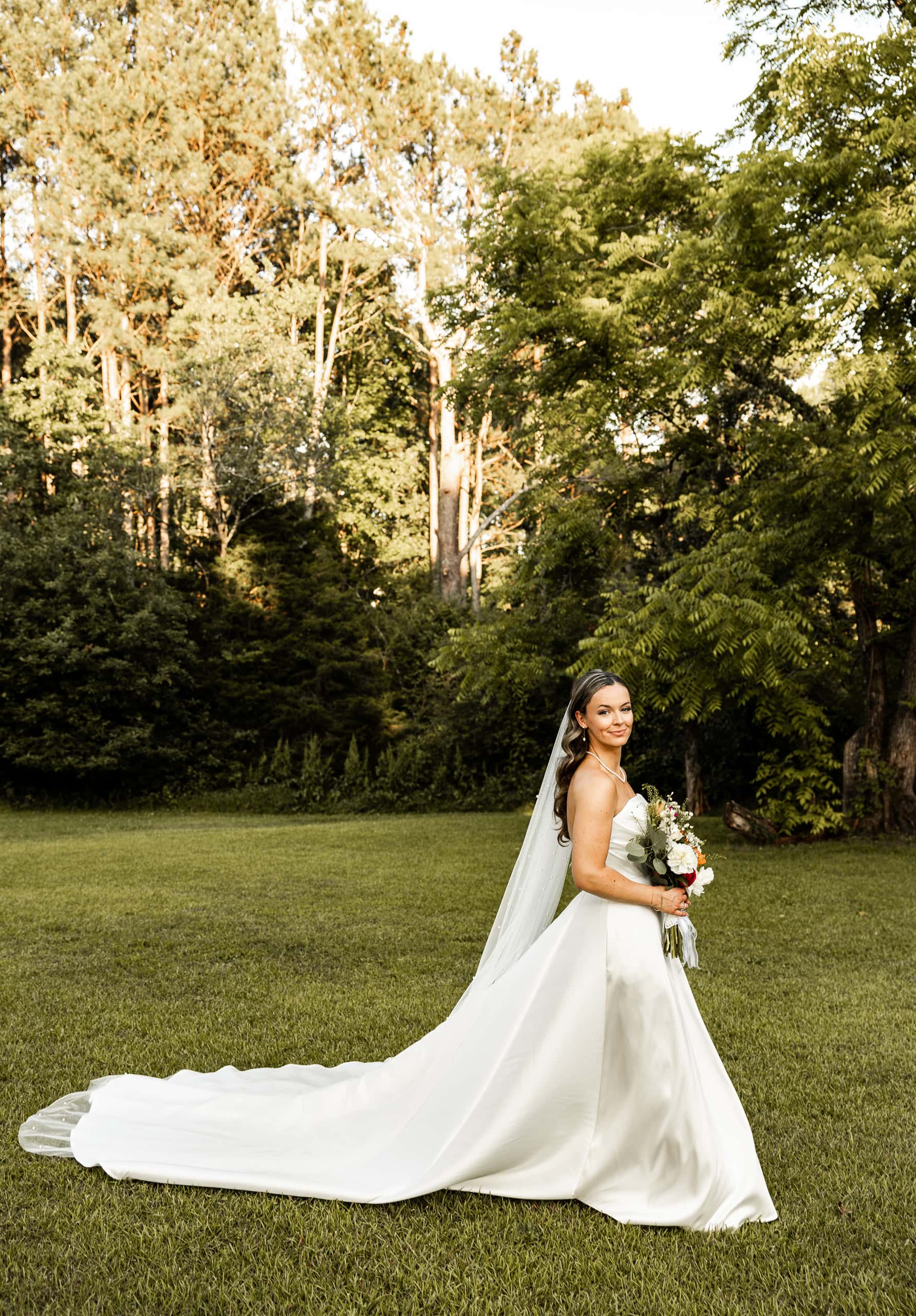 Stunning portrait of Alyssa showcasing her wedding gown in full detail, radiating grace and timeless beauty.