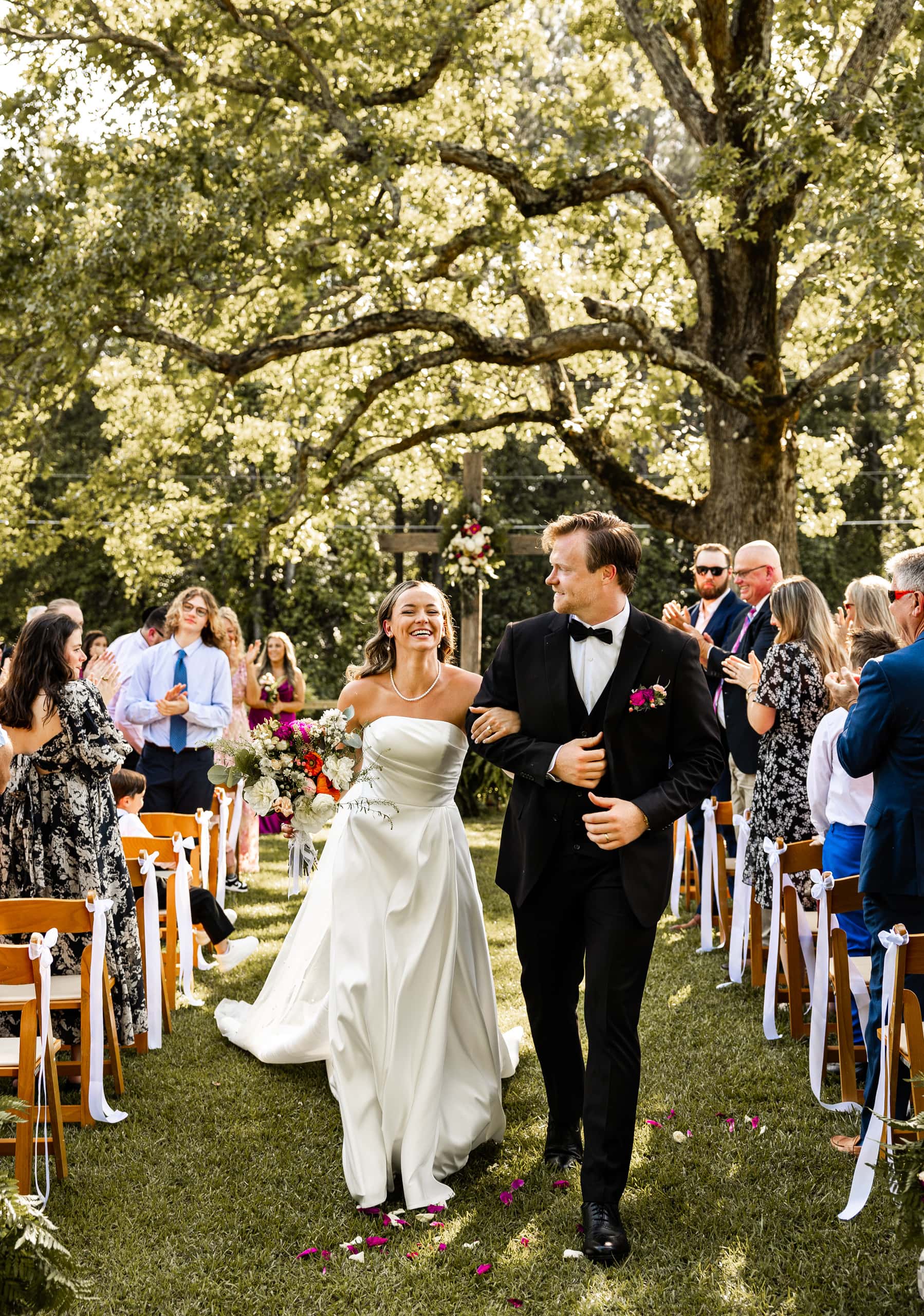 Newlyweds Alyssa and Andrew walking together as husband and wife for the first time, smiling with happiness after the ceremony.