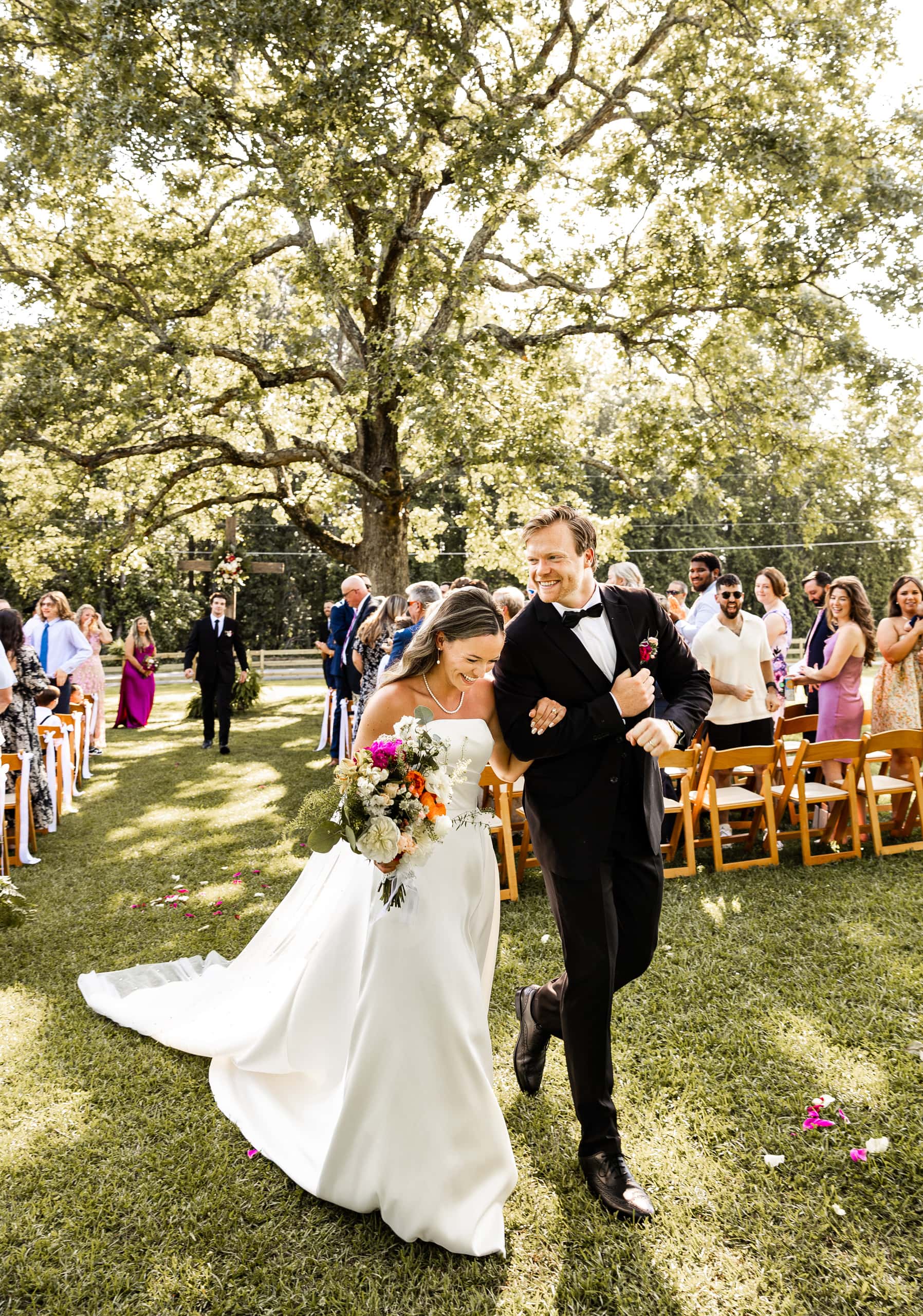 Andrew driving Alyssa by the arm as they leave the ceremony, her face glowing with pure happiness and excitement.