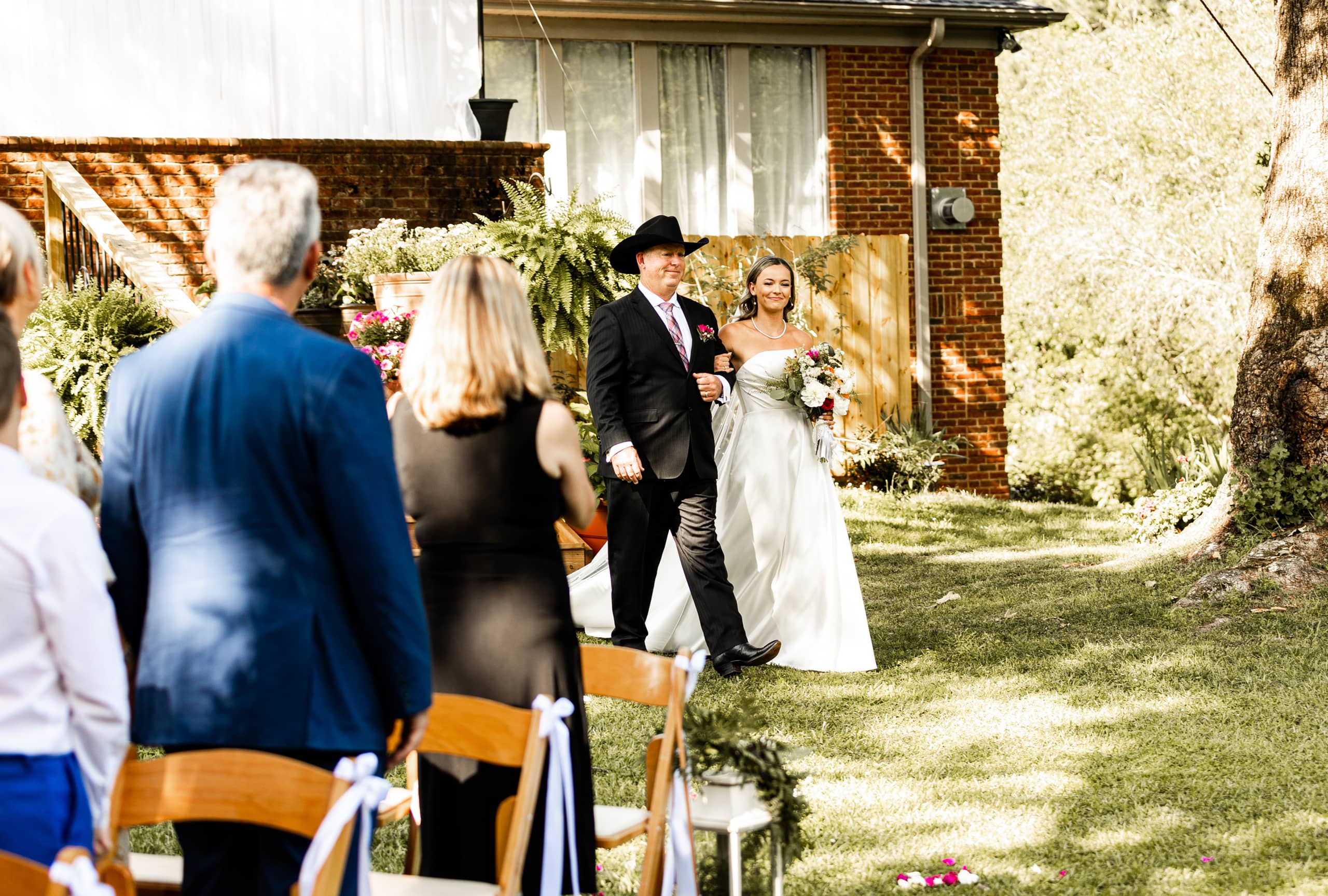 Bride Alyssa walking to the shrine arm in arm with her father, capturing an elegant and emotional pre-ceremony moment.