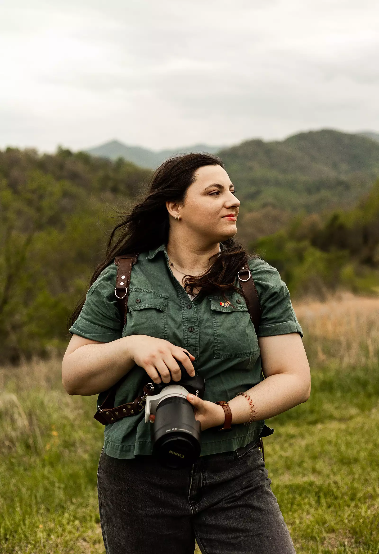 Mădălina Price, destination wedding and adventure elopement photographer, captured in a scenic mountain location.