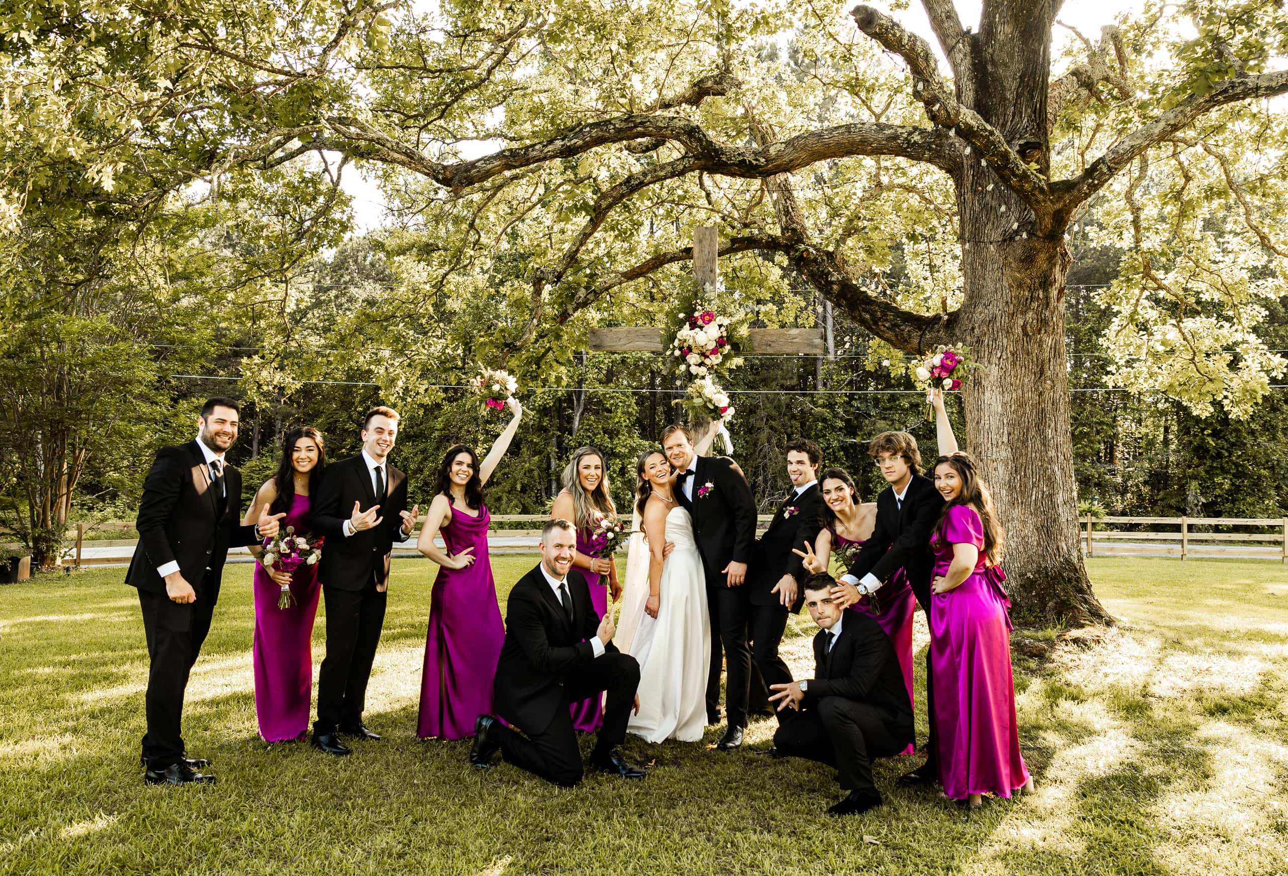 Alyssa and Andrew surrounded by their bridesmaids and groomsmen, captured in a joyful and elegant group photo after the ceremony.