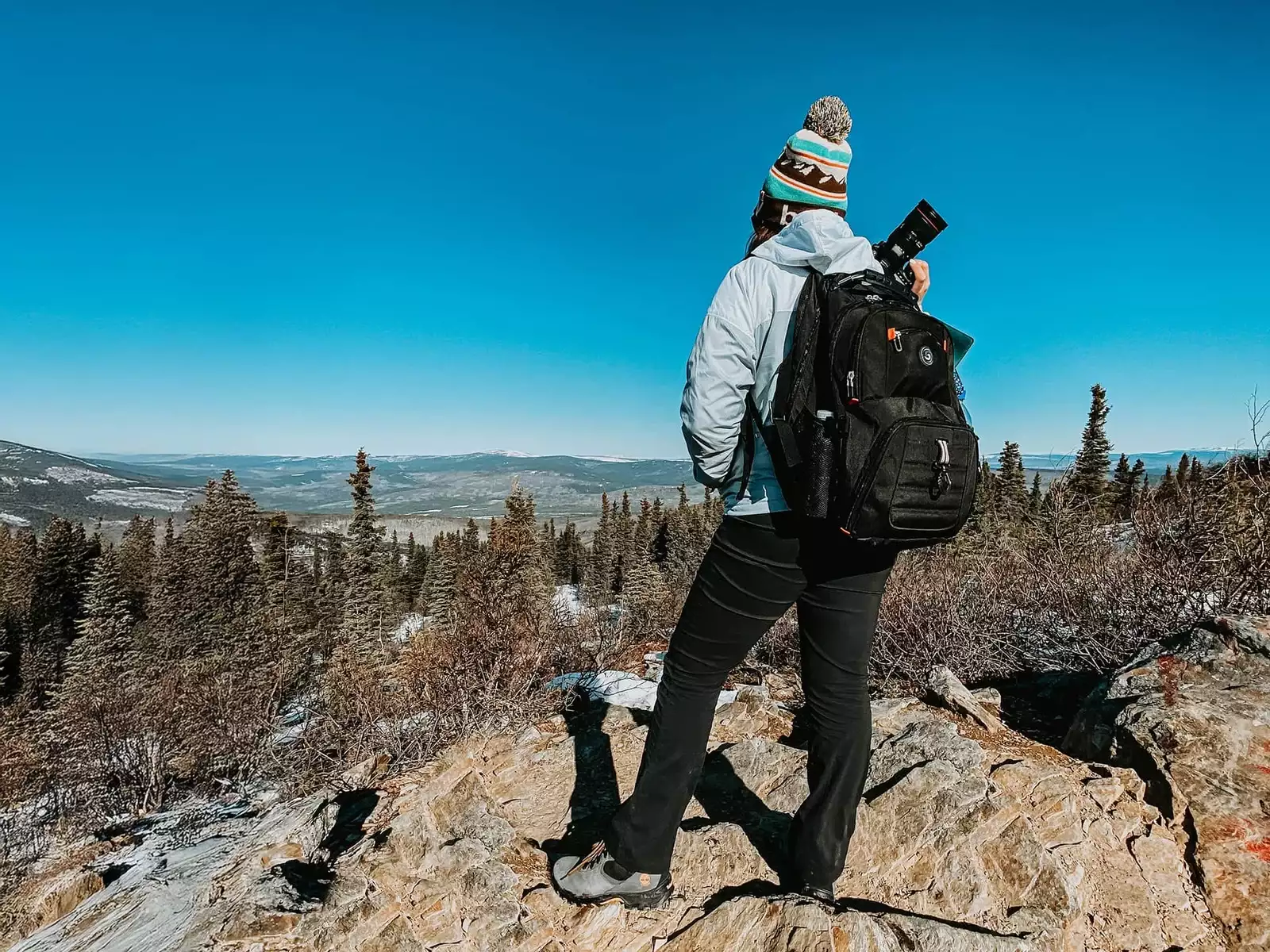 Mădălina Price, destination wedding and adventure elopement photographer, captured in a scenic mountain location.